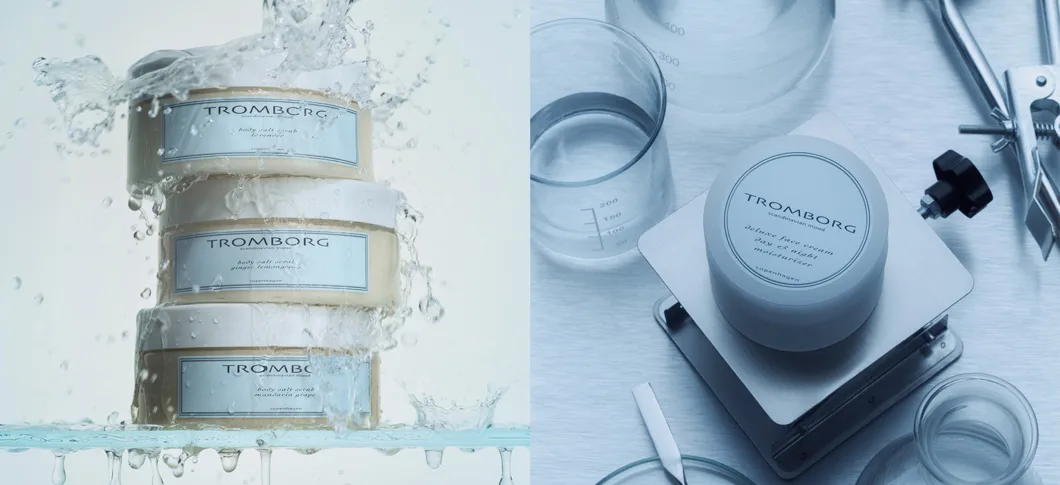 Tromborg produkter. Venstre: Tre body salt scrubs (lavender, ginger lemongrass, mandarin grape) i vandstænk. Højre: Deluxe face cream day & night moisturizer på vægt med labglas.