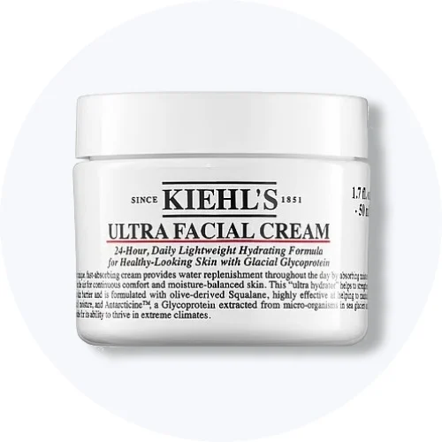 Her ses Kiehl’s Ultra Facial Cream i en hvid krukke på en lysegrå cirkel.