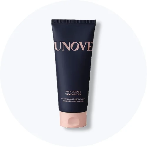 Her ses en UNOVE Deep Damage Treatment EX i mørkeblå emballage med lyserødt låg på en lys baggrund.