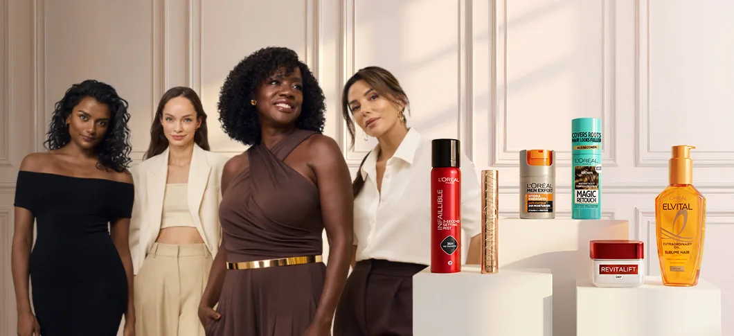 Her ses fire kvinder ved siden af et udvalg af produkter fra L’Oréal Paris inden for makeup, hudpleje, hårpleje og Men Expert.
