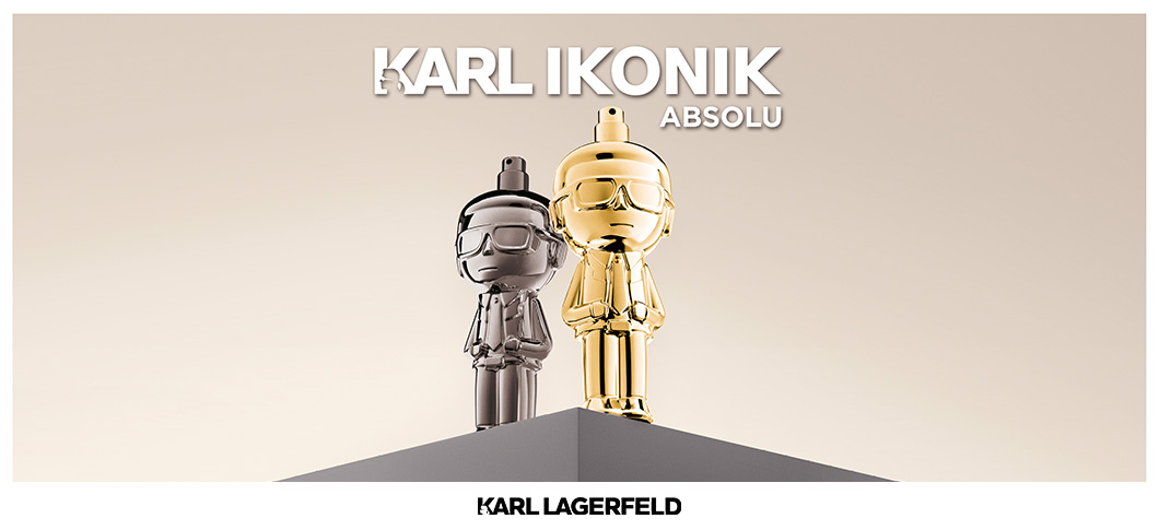 Her ses et billede med to parfumeflakoner formet som figurer placeret på en piedestal mod en lys baggrund. Den ene er i sølvfarve, og den anden er i guldfarve. Øverst står teksten “KARL IKONIK ABSOLU”, og nederst står “KARL LAGERFELD”.