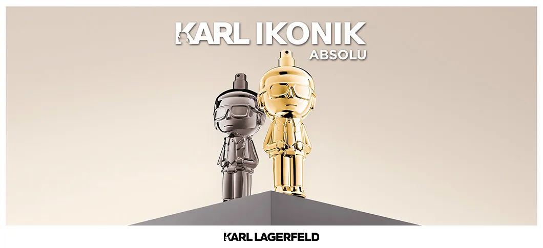 Her ses et billede med to parfumeflakoner formet som figurer placeret på en piedestal mod en lys baggrund. Den ene er i sølvfarve, og den anden er i guldfarve. Øverst står teksten “KARL IKONIK ABSOLU”, og nederst står “KARL LAGERFELD”.