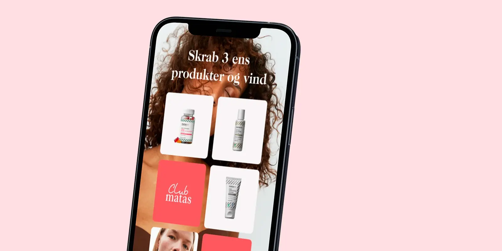 Mobil på lyserød baggrund med app spil vises