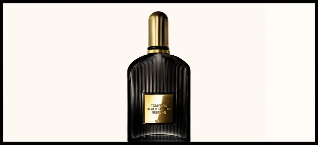 Her ses en sort parfumeflakon med guldlåg på en beige baggrund. Rundt om er en sort ramme.