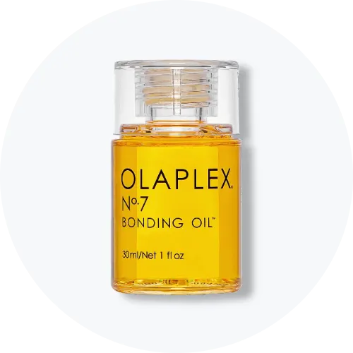 Her ses Olaplex No.7 Bonding Oil i en transparent flaske med gylden hårolie og klart låg. På emballagen står “Olaplex No.7 Bonding Oil” og “30 ml / 1 fl oz”