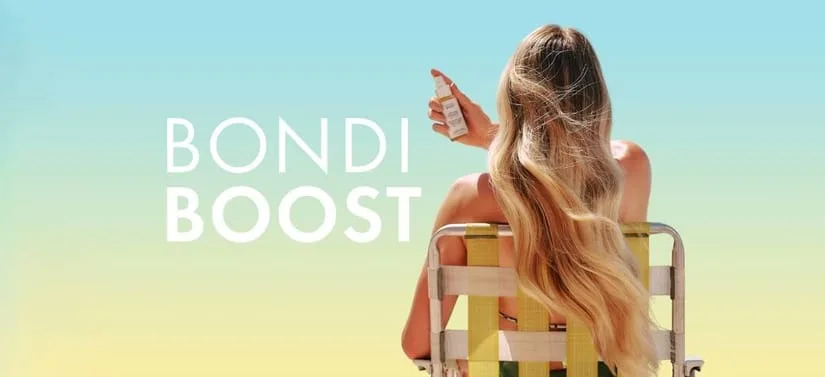 Her ses et billede af en person set bagfra, siddende på en stol mod en gradient baggrund i blå og gul. Personen holder et lille produkt op i hånden. Til venstre i billedet står teksten “BONDI BOOST”.
