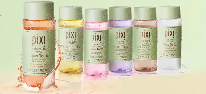 Her ses seks forskellige farvede Pixi Beauty produkter på en lysegrøn baggrund. 