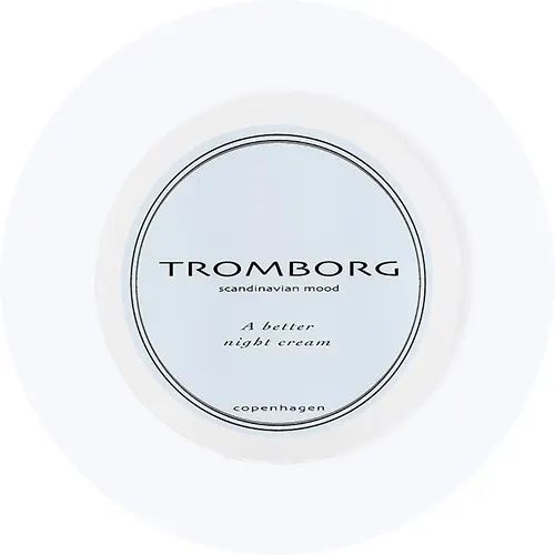 Her ses Tromborg A Better Night Cream i en rund hvid krukke på en lysegrå cirkel.