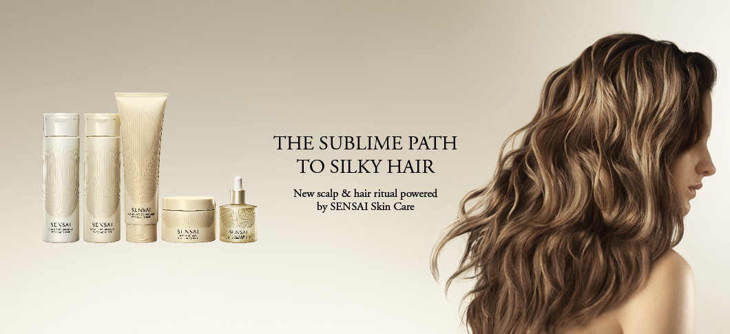 Her ses fem SENSAI hår- og hovedbundsplejeprodukter og en kvinde med langt, bølget hår på en lys beige baggrund med teksten: “THE SUBLIME PATH TO SILKY HAIR. New scalp & hair ritual powered by SENSAI Skin Care.”