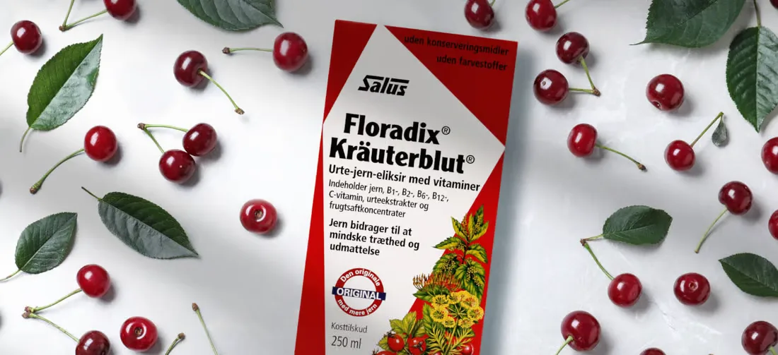 Salus produkt liggende med kirsebær omkring