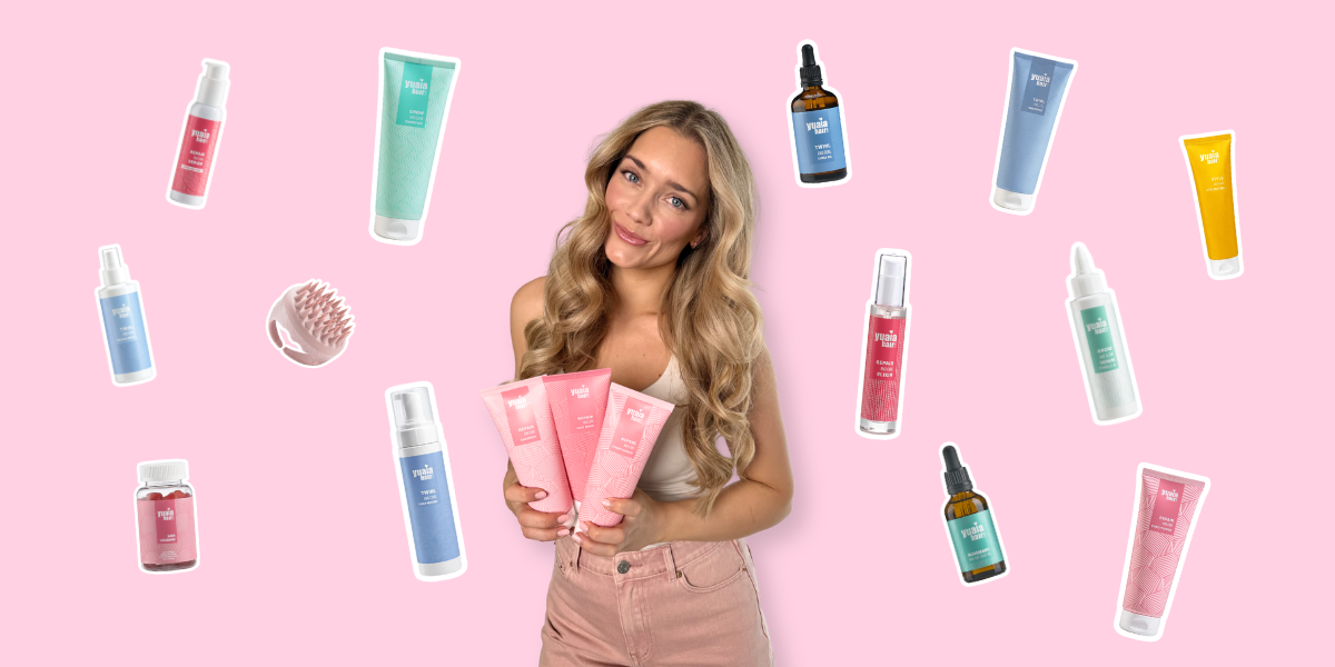 Her ses en kvinde, der holder Yuaia Hair produkter omgivet af små produktikoner og frugter på en lyserød baggrund.