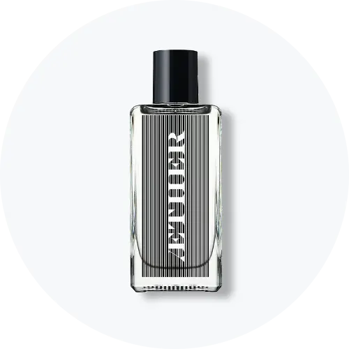 Her ses et billede af en parfumeflakon fra Æther placeret centralt mod en lys, rund baggrund. Flakonen er i klart glas med sort låg og har et grafisk sort-hvidt design på fronten med teksten “ÆTHER”.