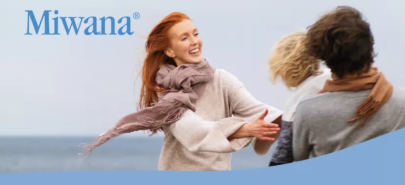 Her ses en kvinde, en mand og et barn, som har det sjovt udenfor. 