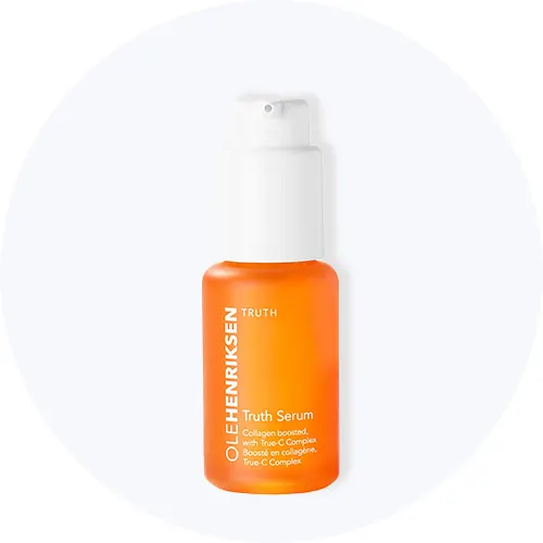 Her ses Ole Henriksen Truth Serum i en orange flaske med pumpe på en lysegrå cirkel.