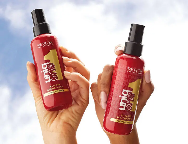 Her ses to Revlon Professional produkter, som holdes op mod himlen i et par hænder.