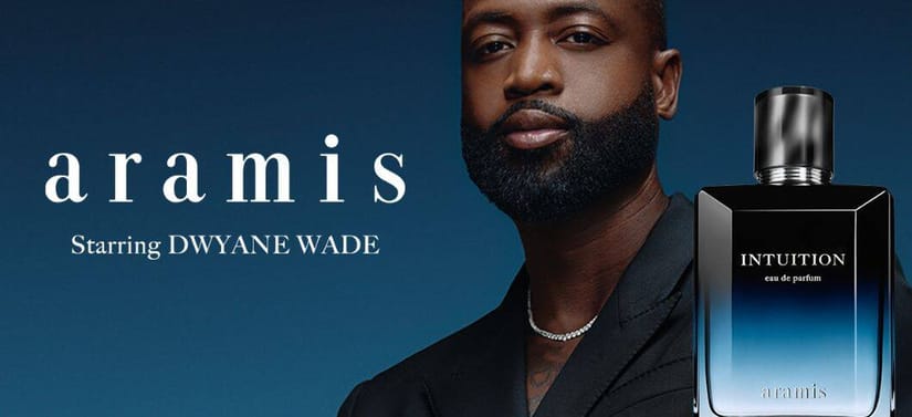 Her ses et billede med en person placeret til venstre mod en blå baggrund samt en parfumeflakon til højre. På billedet står teksten “aramis” og “Starring DWYANE WADE”, og på flakonen står “INTUITION eau de parfum” samt “aramis”.