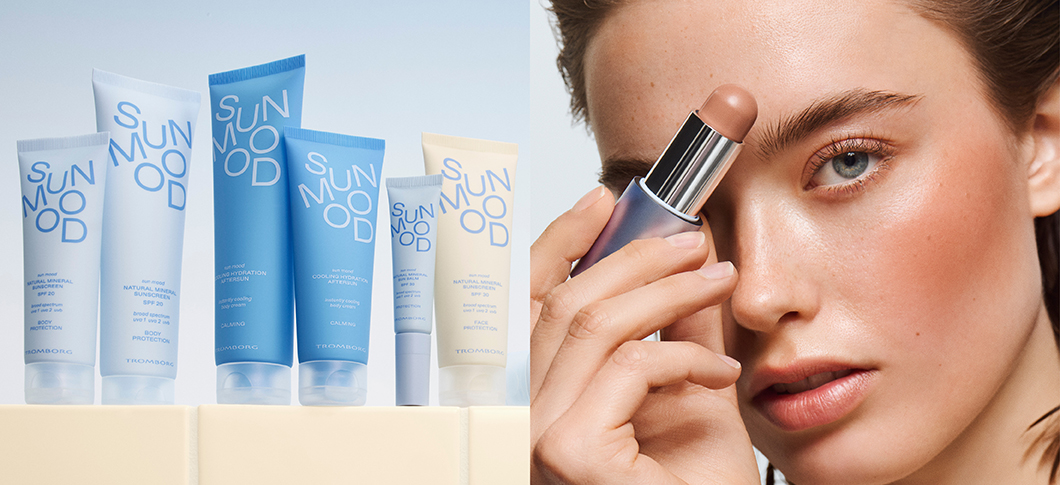 Her ses Tromborg solprodukter i blå emballage ved siden af en kvinde, der holder et makeup-produkt på en lys baggrund.