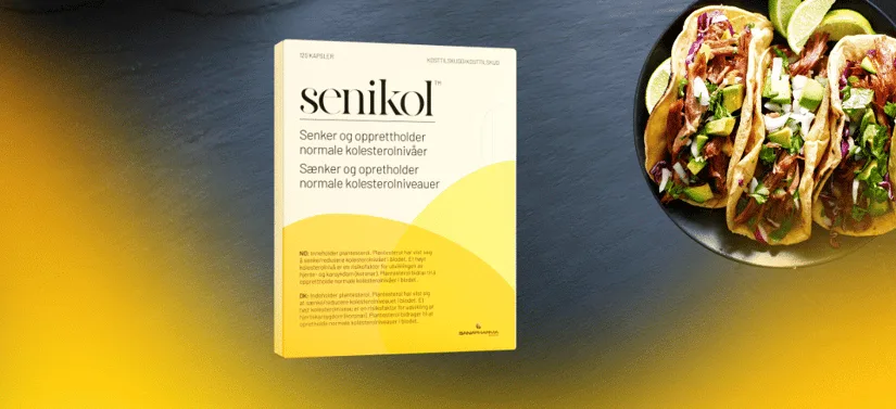Pakke med Senikol kosttilskud står på mørk baggrund med gul farve nederst, ved siden af en tallerken med tacos og lime.