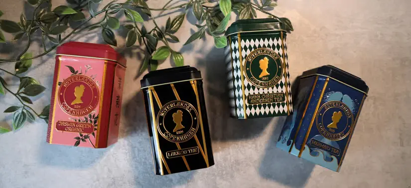 Her ses fire Østerlandsk produkter liggende på en grå baggrund med en grøn gren. 