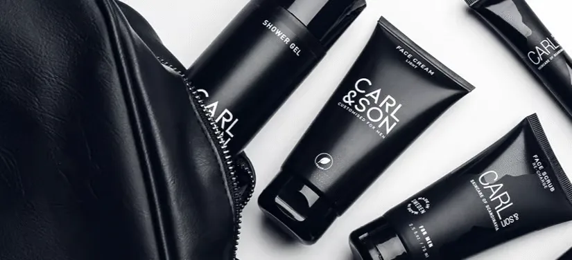 Her ses fire sorte CARL&SON produkter samt en sort toilettaske. Baggrunden er hvid. 