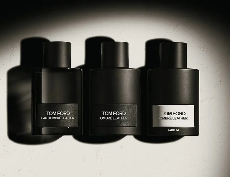 Her ses en grå baggrund med tre sorte Tom Ford parfumer.