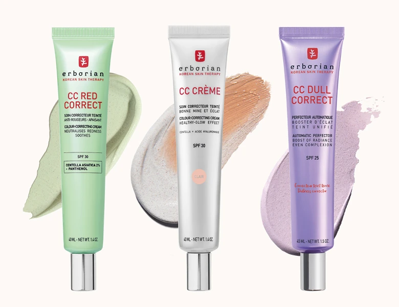 Her ses Erborian CC cremer i grøn, hvid og lilla emballage med produktteksturer på en lys baggrund.