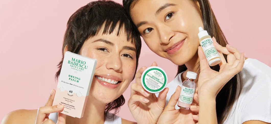 Her ses to Mario Badescu produkter på en grøn baggrund. I midten ses Mario Badescu logoet.