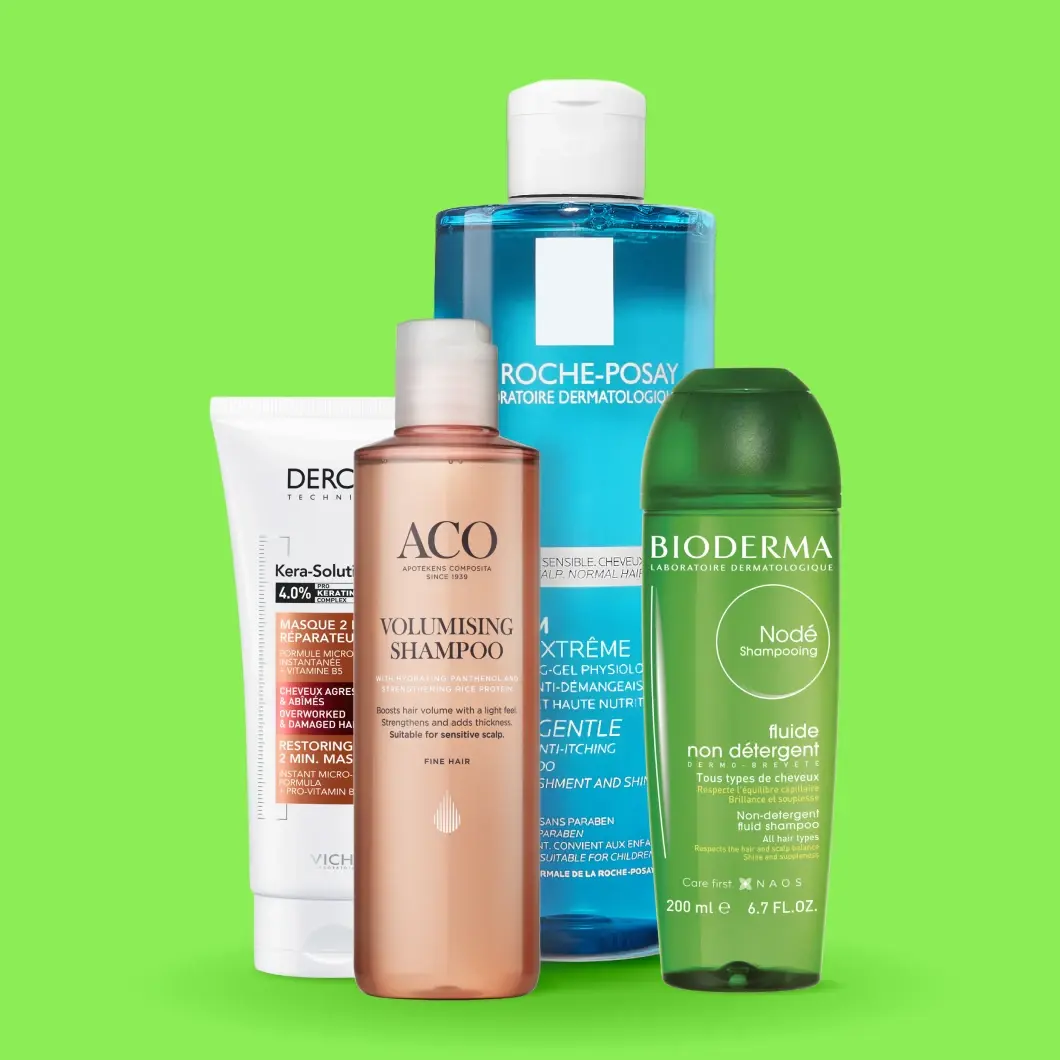 Hårvårdsprodukter från Vichy Dercos Kera-Solutions Restoring 2 Min. Mask, ACO Volumising Shampoo, La Roche-Posay Kerium Doux Extrême Gentle Shampoo och Bioderma Nodé Fluide Non-Detergent Fluid Shampoo. Produkterna visas i vita, rosa, blå och gröna förpackningar mot en ljusgrön bakgrund.