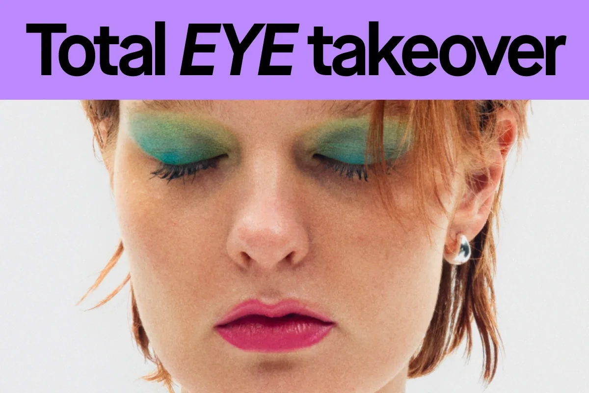 Texten “Total EYE takeover” visas tillsammans med en person med grön ögonskugga, mascara på fransarna och rosa läppstift.