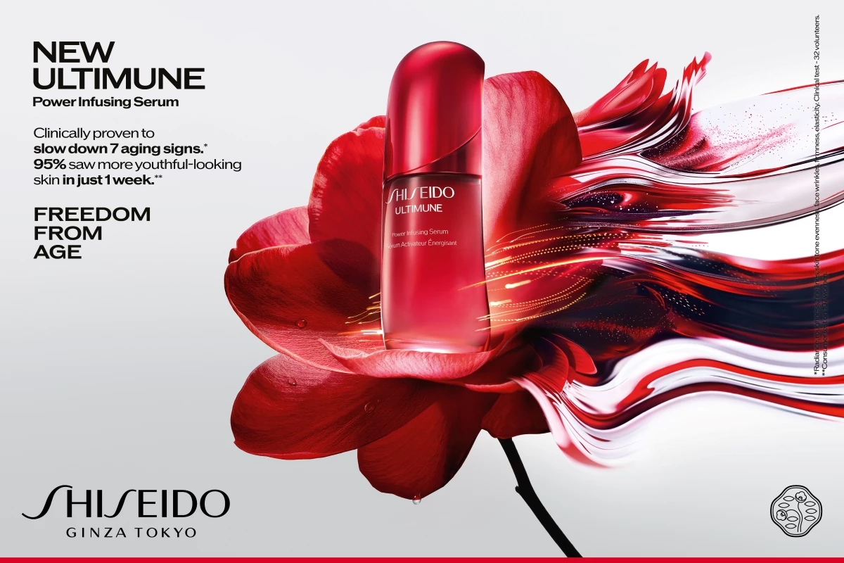 Shiseidon punainen pullo on sijoitettu suuren punaisen kukan eteen. Kuvan teksti kuuluu: ”New Ultimune Power Infusing Serum. Kliinisesti todistetusti hidastaa 7 ikääntymisen merkkiä. 95 % näki nuorekkaamman näköisen ihon vain 1 viikossa. Vapaus iästä. Shiseido Ginza Tokyo.”