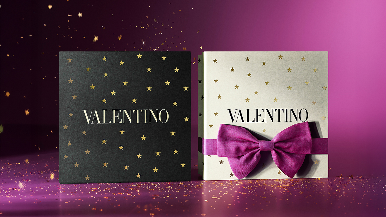 To Valentino couture-gavesett: hvit stjernemønstret Donna Born In Roma Intense og svart maskulin Uomo Born In Roma EdT. Perfekte julegaver på lilla glitrende bakgrunn.