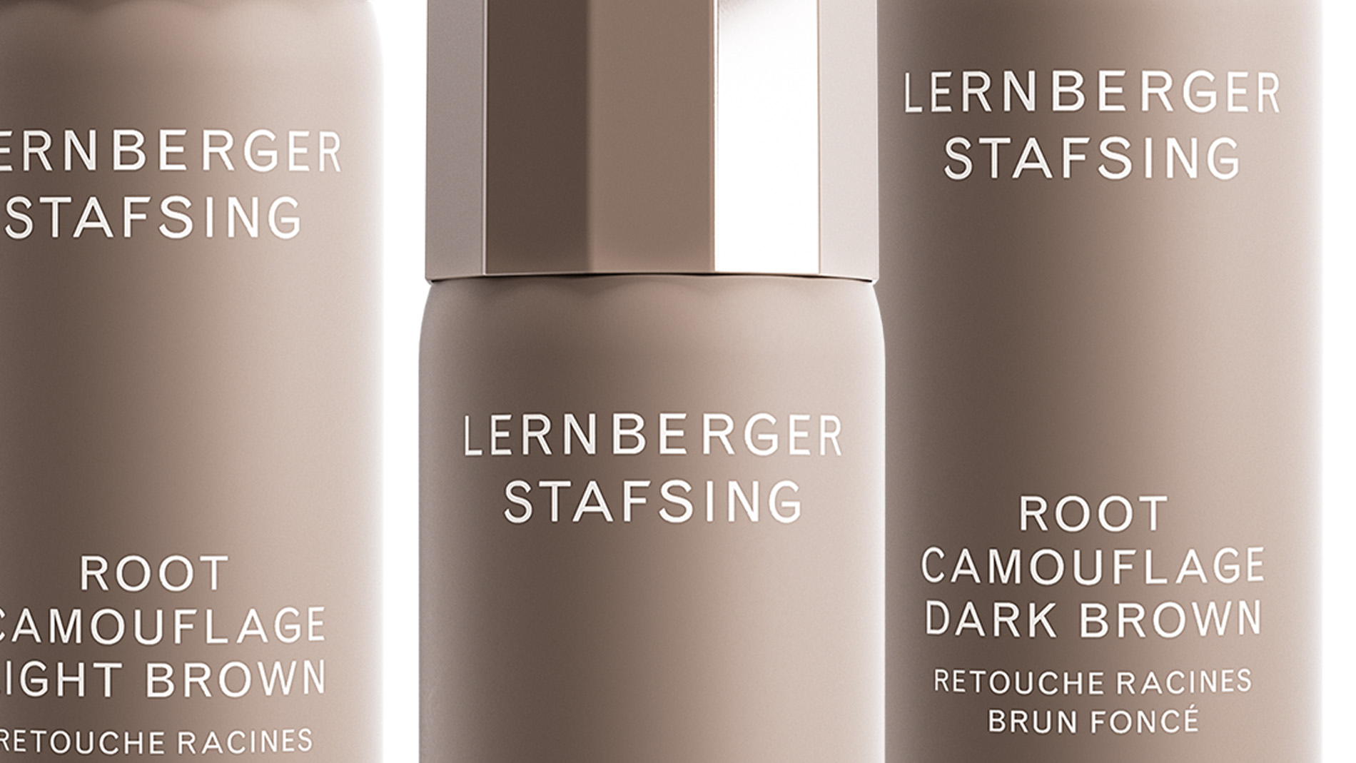 Tre flaskor Root Camouflage Dark Blonde från Lernberger Stafsing i varierande höjd, mot en vit bakgrund.