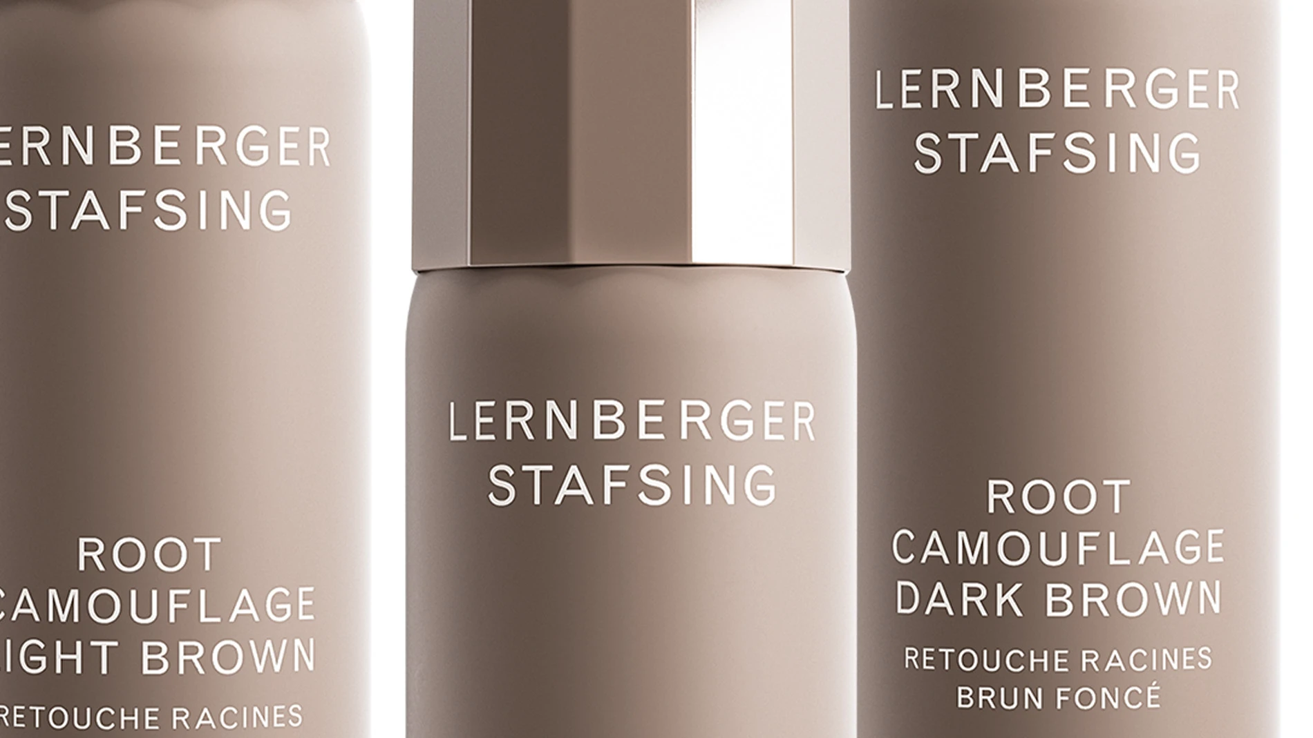 Tre flaskor Root Camouflage Dark Blonde från Lernberger Stafsing i varierande höjd, mot en vit bakgrund.