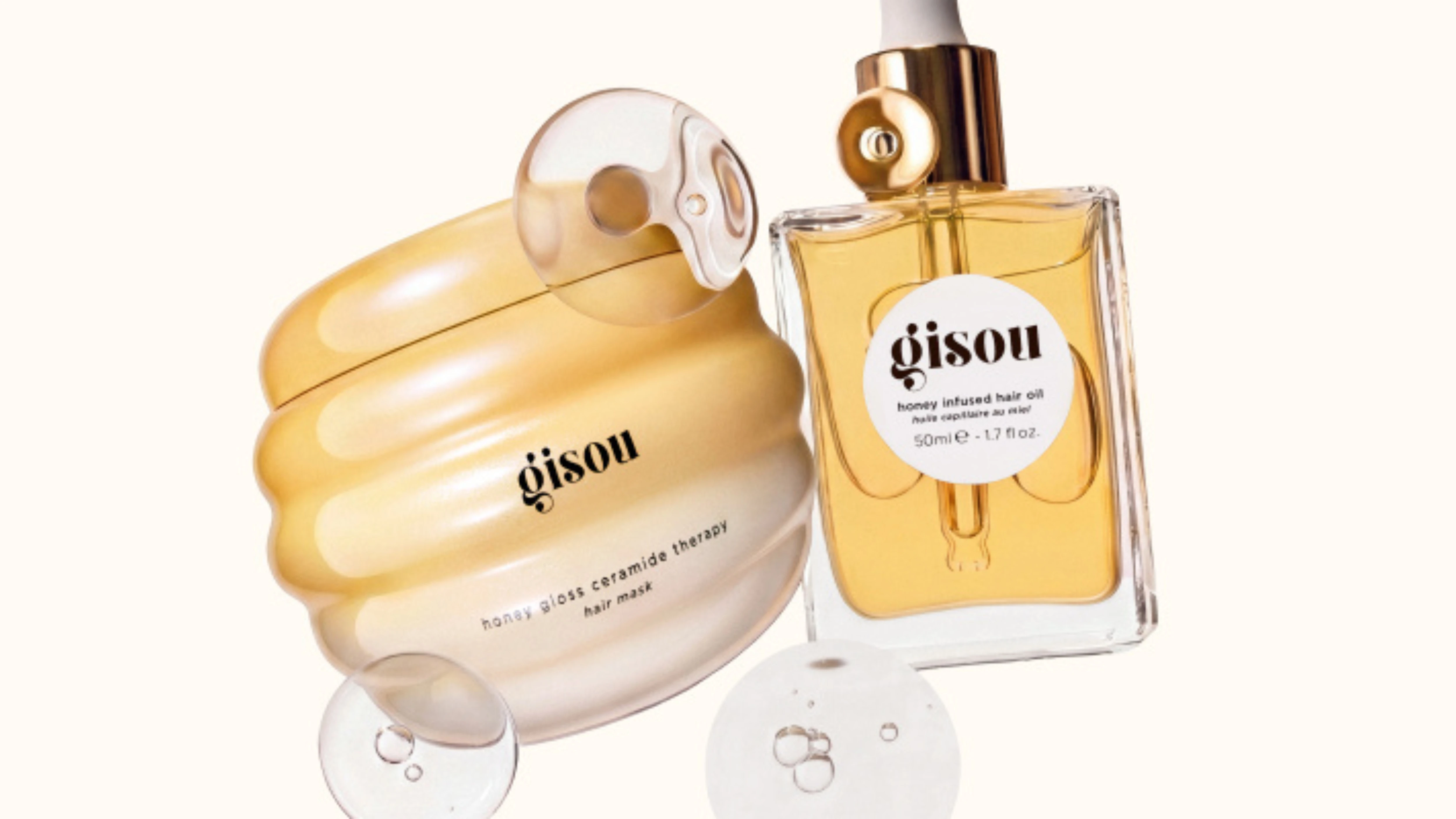 Gisou hårprodukter: Honey Gloss Ceramide Therapy hårmaske i gul krukke og Honey Infused Hair Oil-flaske (50ml).