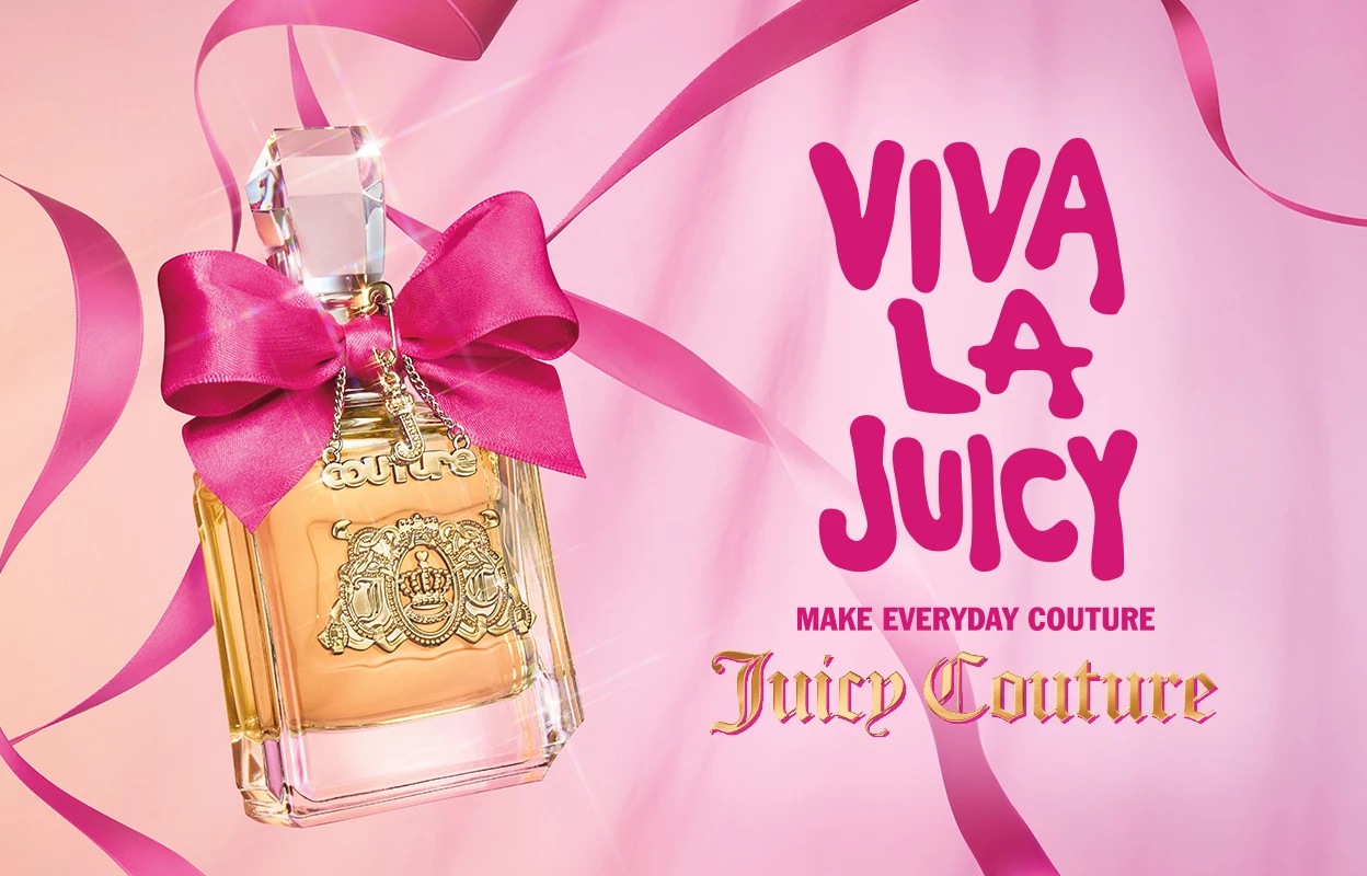 Juicy Couture -hajuvesipullo, jossa on vaaleanpunainen rusetti kaulan ympärillä, vaaleanpunaisella taustalla teksti ”Viva La Juicy” ja ”Make Everyday Couture”.