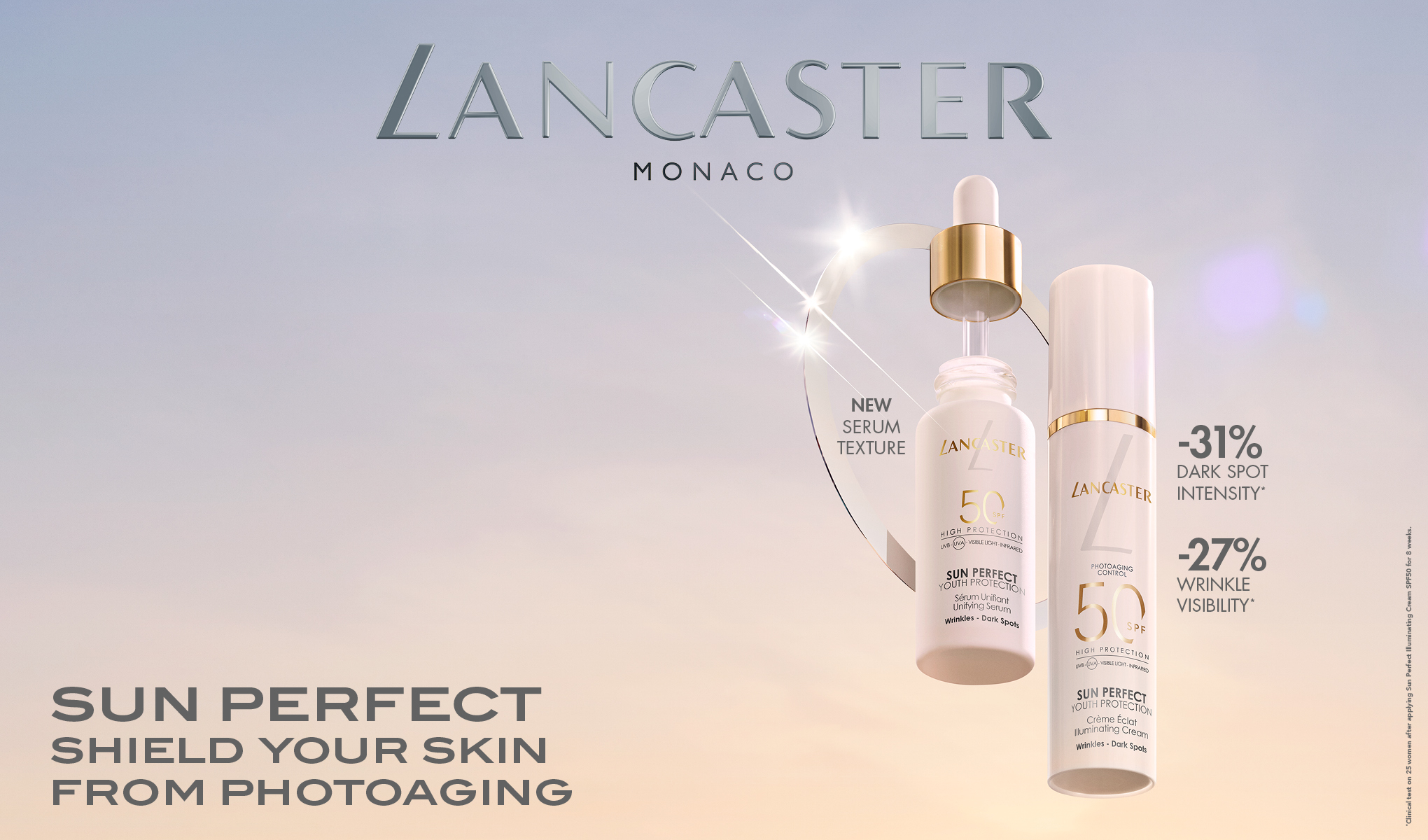 To Lancaster solbeskyttelsesprodukter står mot en lys bakgrunn. Teksten "SUN PERFECT SHIELD YOUR SKIN FROM PHOTOAGING" er skrevet nederst, sammen med informasjon om produktets egenskaper.