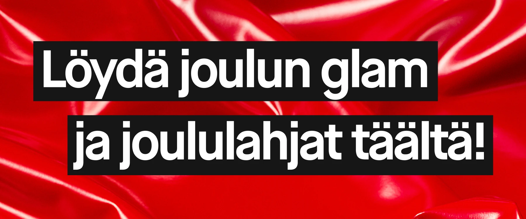 Banneri, jossa teksti "Löydä joulun glam ja joululahjat täältä!" punaisella kiiltävällä kangastaustalla.
