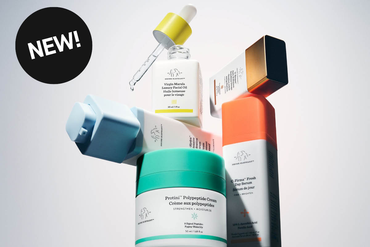 Drunk Elephant hudvårdsprodukter med serum, ansiktsolja och ansiktskräm arrangerade mot ljus bakgrund. Synlig text inkluderar “NEW!”, Virgin Marula Luxury Facial Oil, Protini Polypeptide Cream och C-Firma Fresh Day Serum med färgstarka förpackningar i turkos, orange, gul och blå design.
