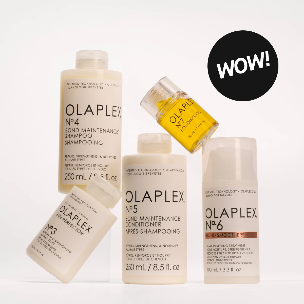 Olaplex hårpleieprodukter, inkludert sjampo, balsam, hårolje, hårperfector og bond smoother. Flaskene er plassert mot en hvit bakgrunn.