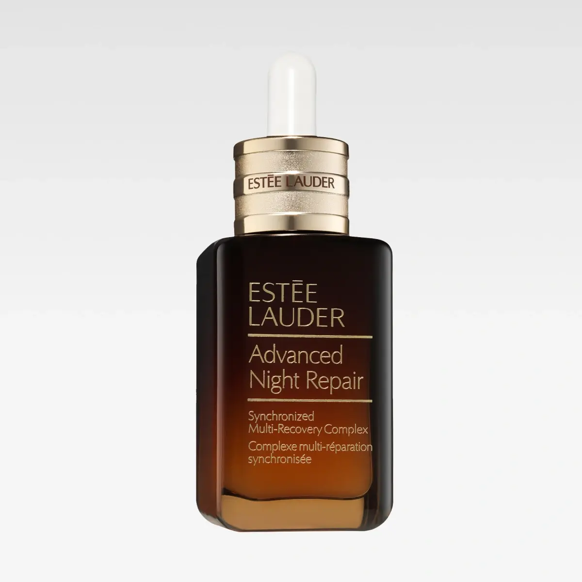 Brun glasflaska Estée Lauder Advanced Night Repair med pipett och text “Synchronized Multi-Recovery Complex”.