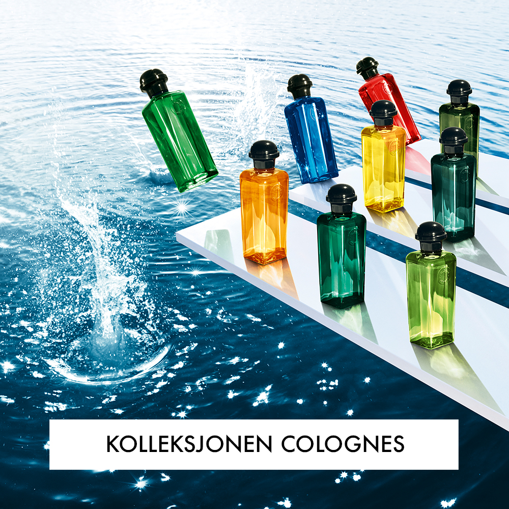 Flere parfymeflasker fra Hermès, plassert på hvite plattformer over en vannkilde. En av flaskene er i ferd med å falle ned i vannet, og teksten "Kolleksjonen Colognes" vises nederst.