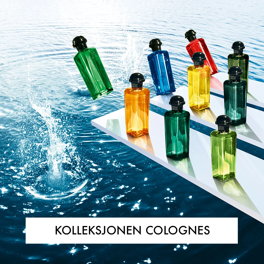 Flere parfymeflasker fra Hermès, plassert på hvite plattformer over en vannkilde. En av flaskene er i ferd med å falle ned i vannet, og teksten "Kolleksjonen Colognes" vises nederst.