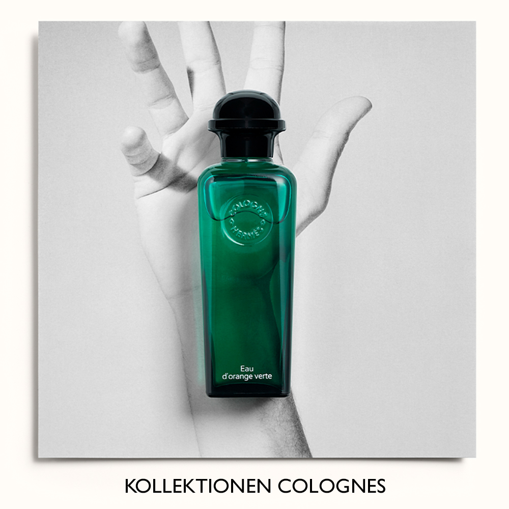Parfymflaska från Hermès, Eau d'orange verte, placerad framför en svartvit bild av en hand. Texten "Kollektionen Colognes" syns längst ner.