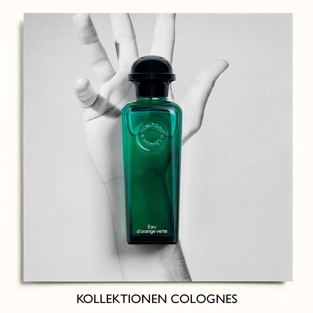 Parfymflaska från Hermès, Eau d'orange verte, placerad framför en svartvit bild av en hand. Texten "Kollektionen Colognes" syns längst ner.