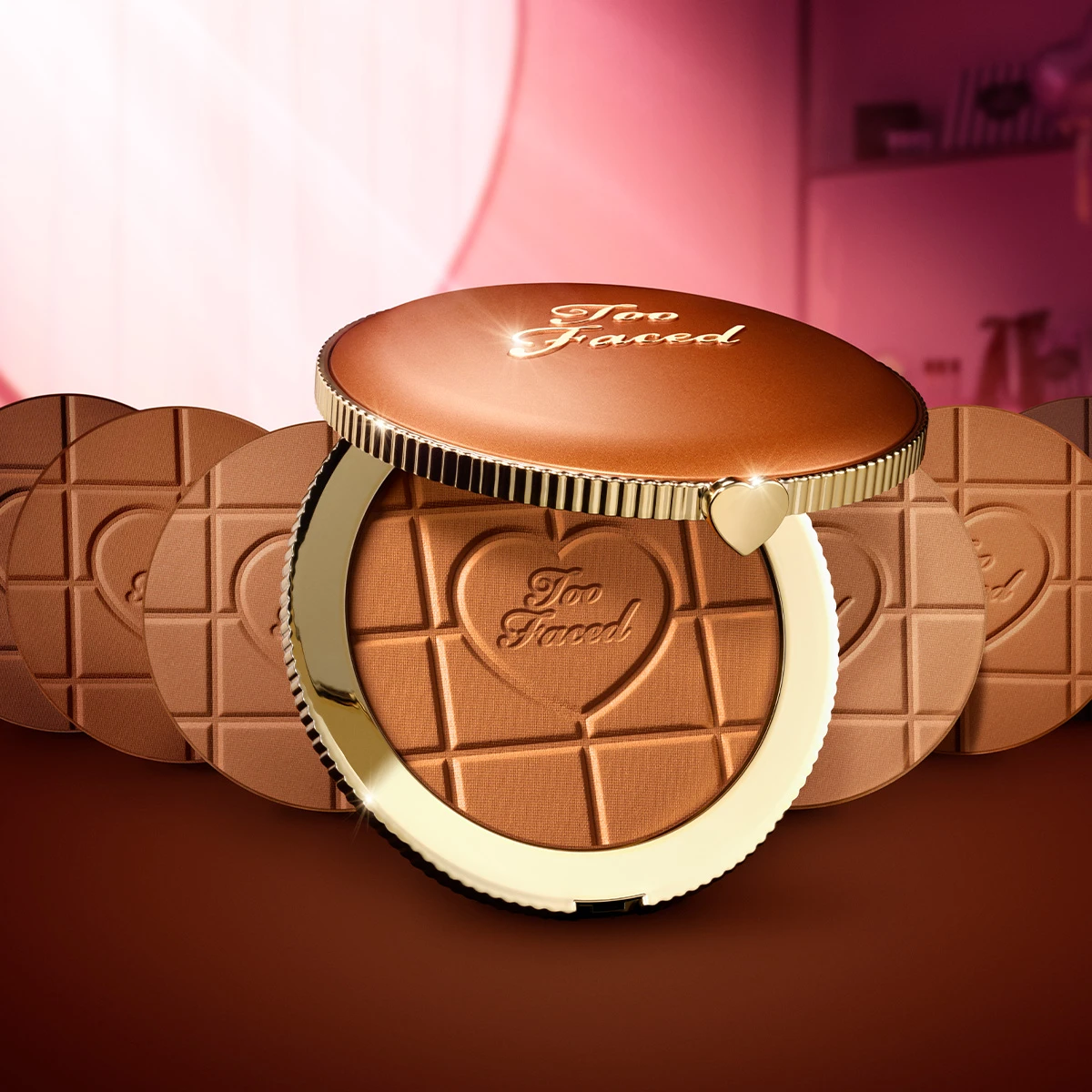 Too Faced -aurinkopuuteri avatussa pyöreässä rasiassa, jossa suklaalevyn kuviointi.