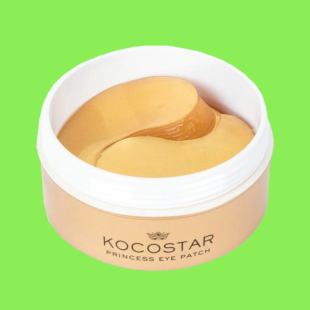 Burk med ögonmasker märkt “KOCOSTAR PRINCESS EYE PATCH” med guldfärgade hydrogel patches mot grön bakgrund.