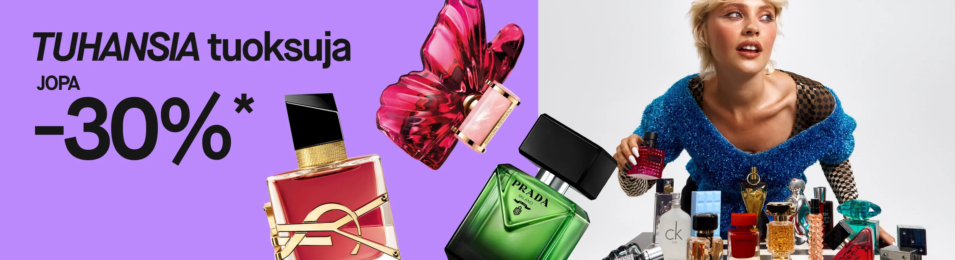 Tuhansia hajuvesiä, jopa 30%*. Violetilla taustalla näkyy suuria hajuvesipulloja muun muassa Pradalta ja YSL:ltä sekä henkilö, joka pitää punaista Valentino-hajuvettä hajuvesipulloilla täytetyn pöydän äärellä.