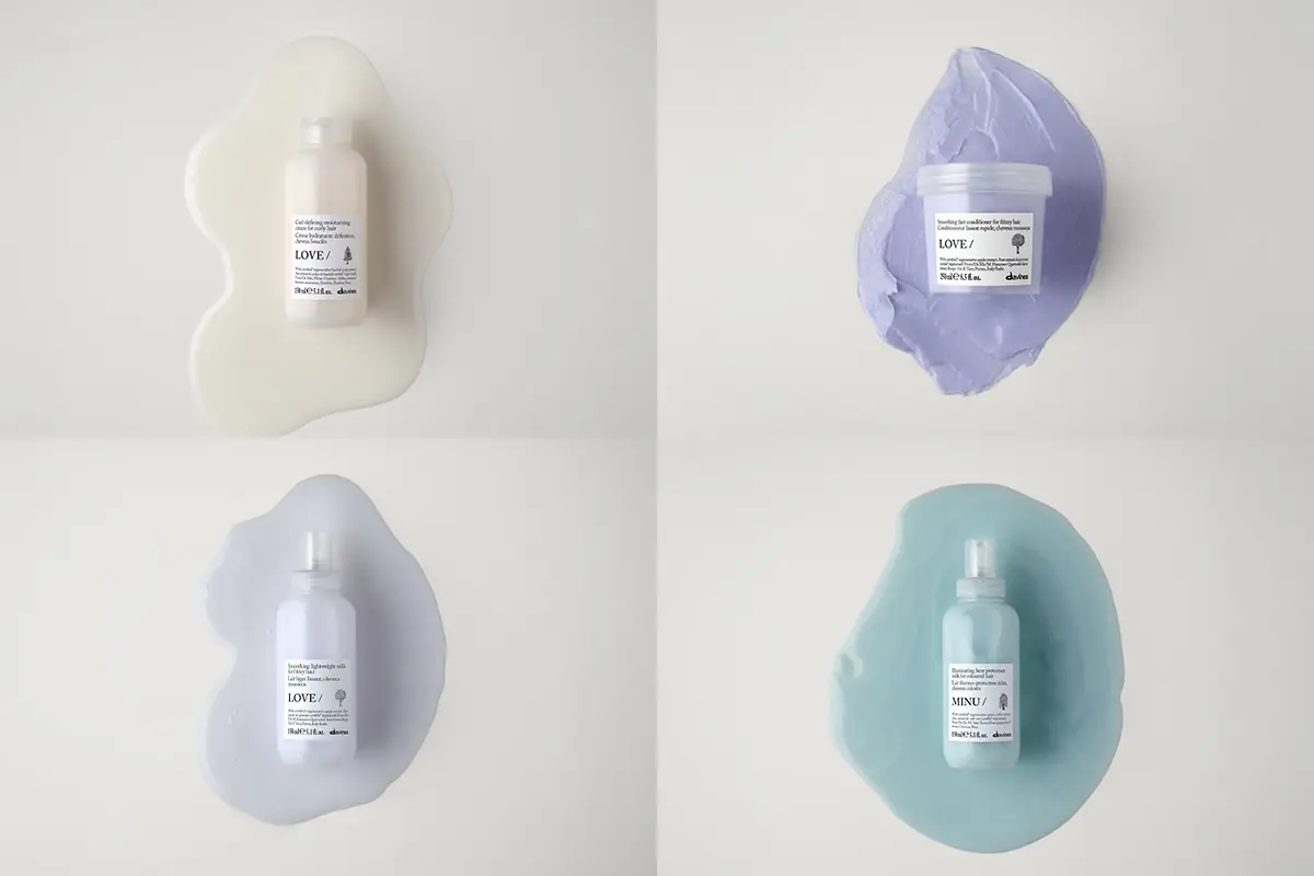 Fyra Davines hårvårdsprodukter från serierna LOVE och MINU visas mot vit bakgrund med utstrukna produkttexturer i vitt, ljuslila, turkos och lila bakom förpackningarna. Bilden innehåller schampo, hårmask och hårvårdsprodukter med synliga etiketter där “LOVE/”, “MINU/” och Davines-logotypen framgår.