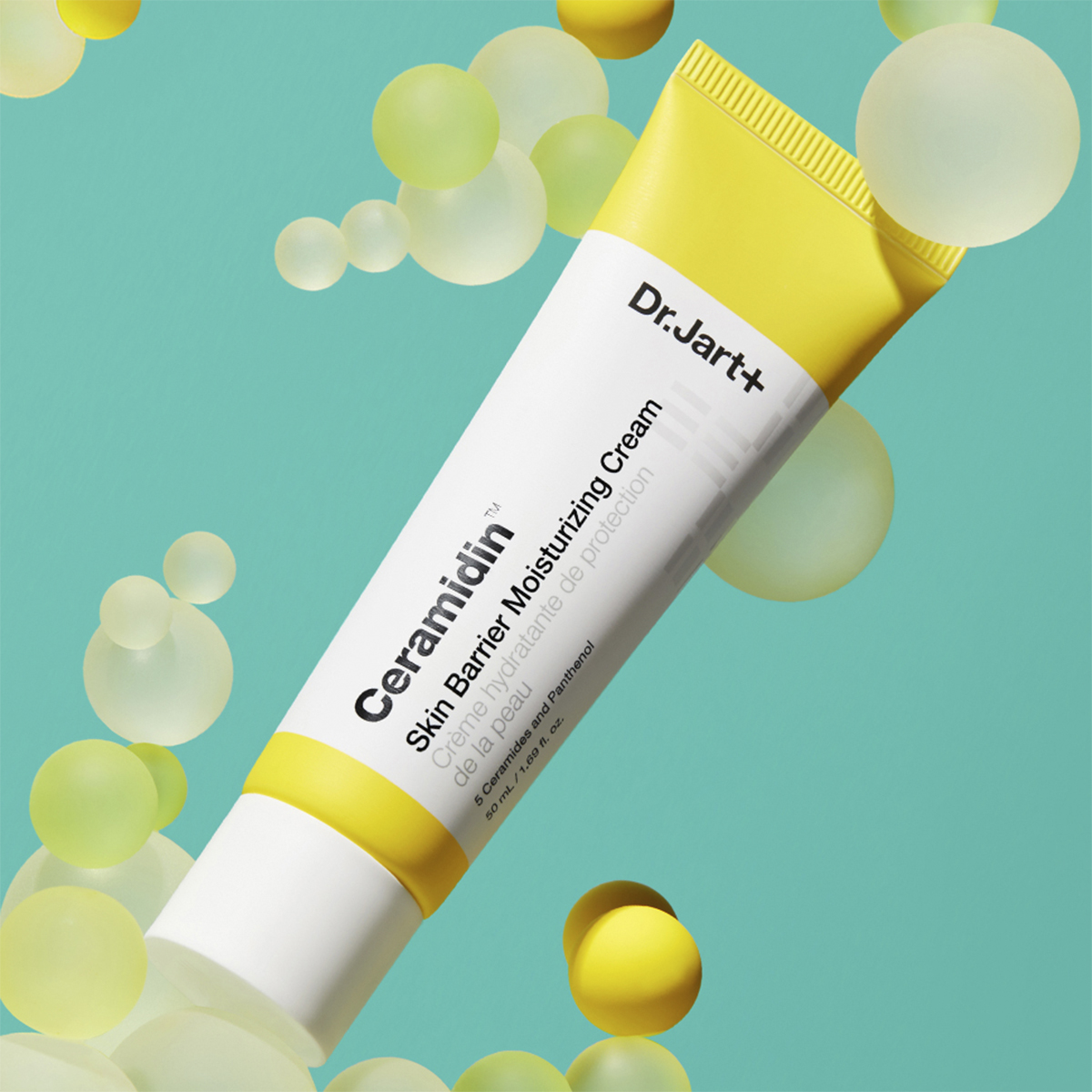 Dr.Jart+ Ceramidin Skin Barrier Moisturising Cream -tuubi turkoosilla pohjalla, jossa on keltaisia ja valkoisia kuplia.
