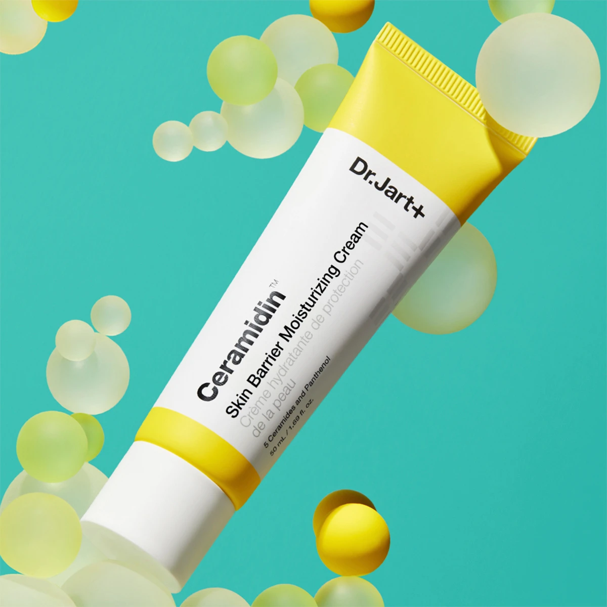 Dr.Jart+ Ceramidin Skin Barrier Moisturising Cream -tuubi turkoosilla pohjalla, jossa on keltaisia ja valkoisia kuplia.